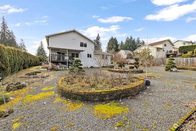 back of property featuring a wooden deck