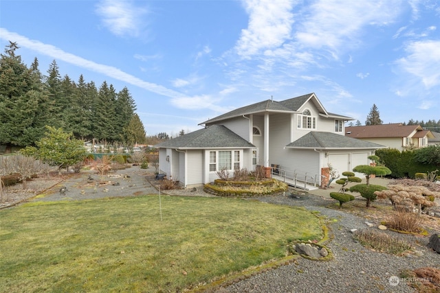 view of front facade with a garage and a front lawn