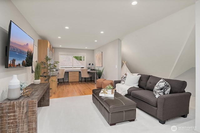 living area with recessed lighting and light wood-style floors