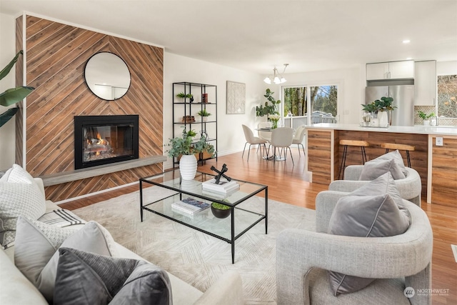 living room with a notable chandelier and light hardwood / wood-style floors