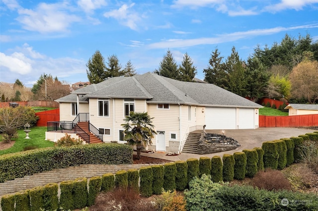 rear view of property featuring a garage