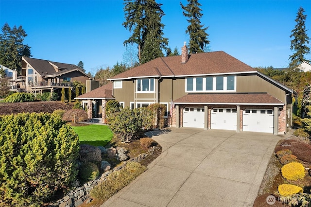 view of front of house with an attached garage, driveway, a chimney, and a shingled roof