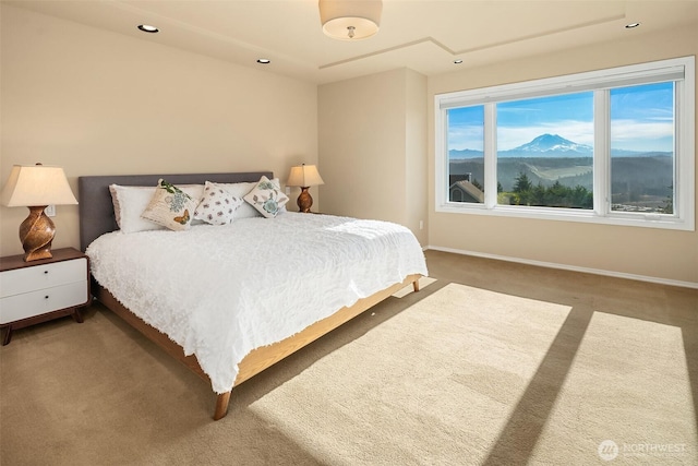 carpeted bedroom featuring recessed lighting, a mountain view, and baseboards