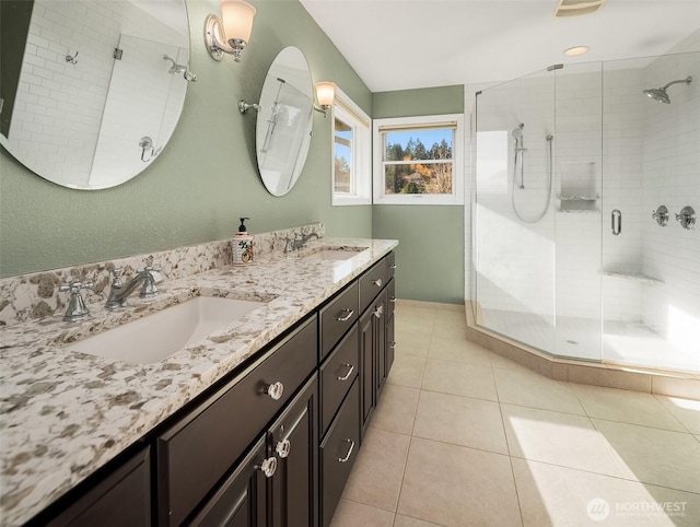 bathroom featuring a sink, a shower stall, and double vanity