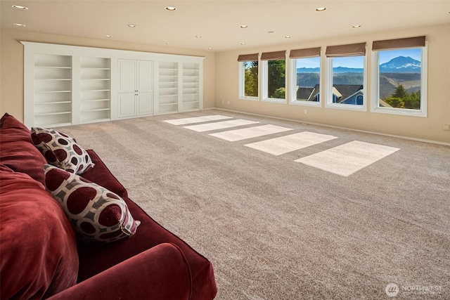 living room with carpet, built in features, baseboards, and recessed lighting