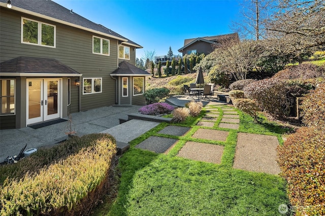 view of yard with french doors and a patio