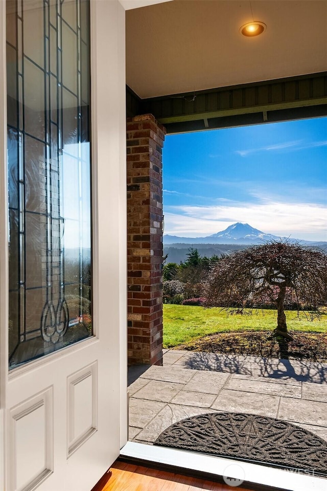 doorway featuring a mountain view and wood finished floors