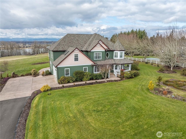 view of front of house featuring a garage and a front lawn