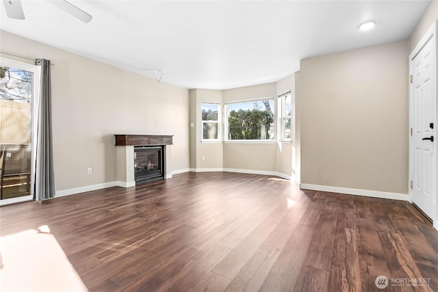 unfurnished living room with ceiling fan and dark hardwood / wood-style floors