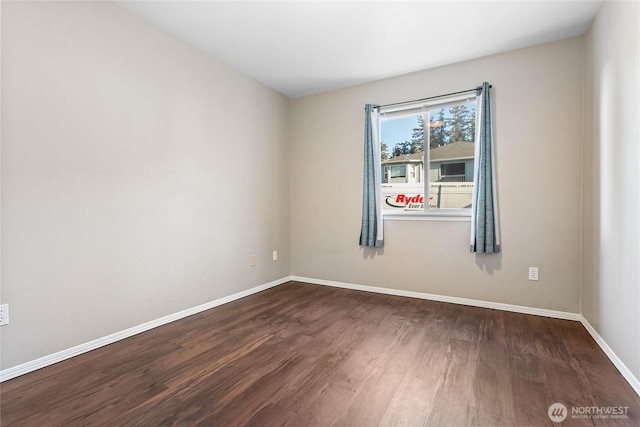 spare room featuring dark wood-type flooring