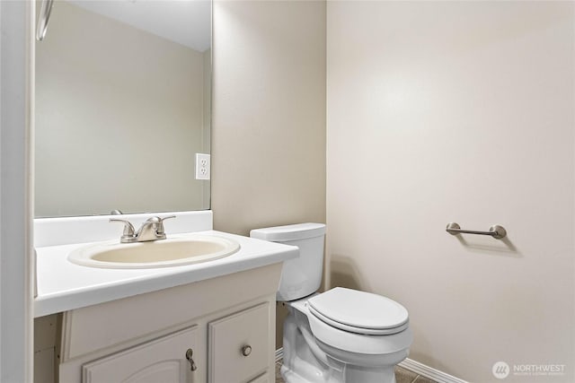 bathroom featuring vanity and toilet