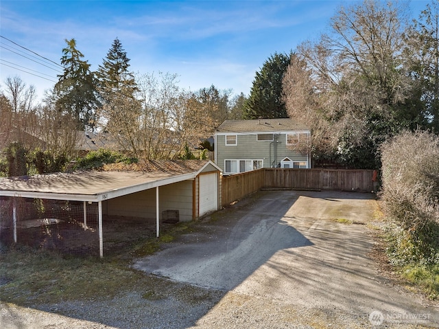 view of side of property with a garage and a carport