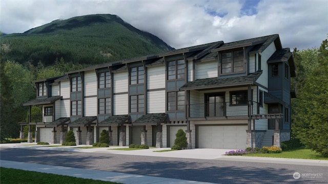 multi unit property featuring a garage and a mountain view