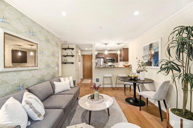 living room featuring ornamental molding and light hardwood / wood-style floors