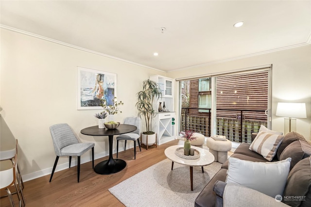 living room featuring ornamental molding and hardwood / wood-style floors