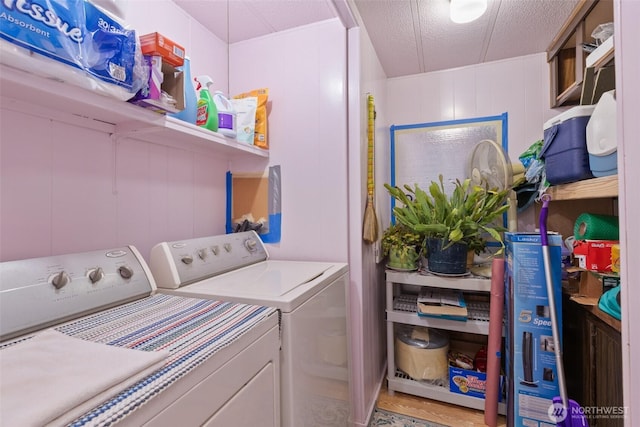 washroom with separate washer and dryer and a textured ceiling