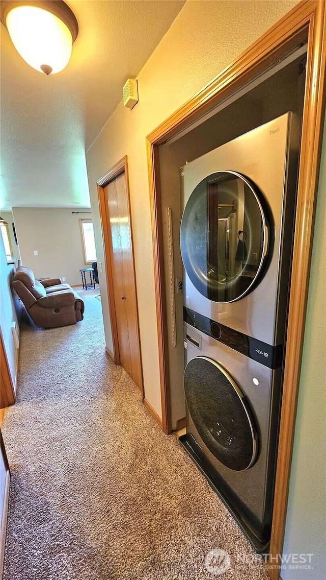 617 W Horton Way Unit 207, Bellingham, WA 98226 - laundry room with estacked washer and dryer, carpet flooring, and baseboards