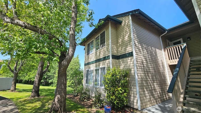617 W Horton Way Unit 207, Bellingham, WA 98226 - view of property exterior featuring stairs and a lawn