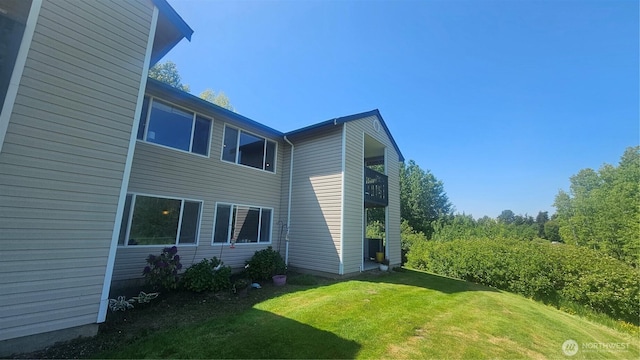617 W Horton Way Unit 207, Bellingham, WA 98226 - view of property exterior with a lawn and a balcony