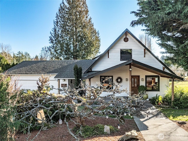 view of front of property featuring a garage and a shingled roof