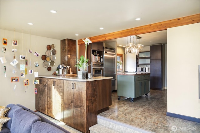 kitchen with a kitchen island, appliances with stainless steel finishes, open floor plan, beamed ceiling, and recessed lighting