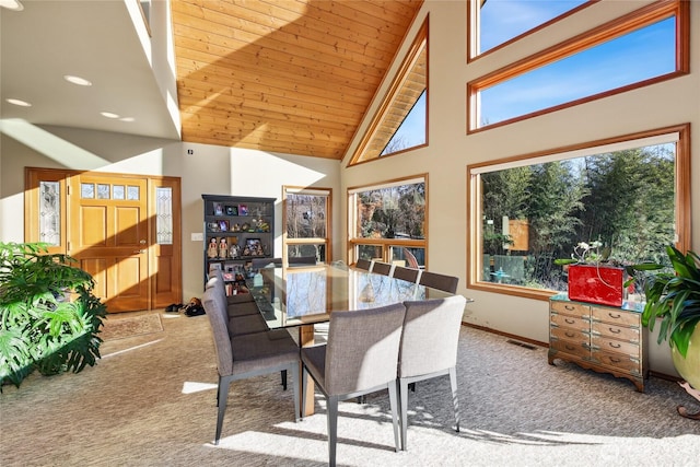 carpeted dining room featuring high vaulted ceiling, wooden ceiling, visible vents, and baseboards