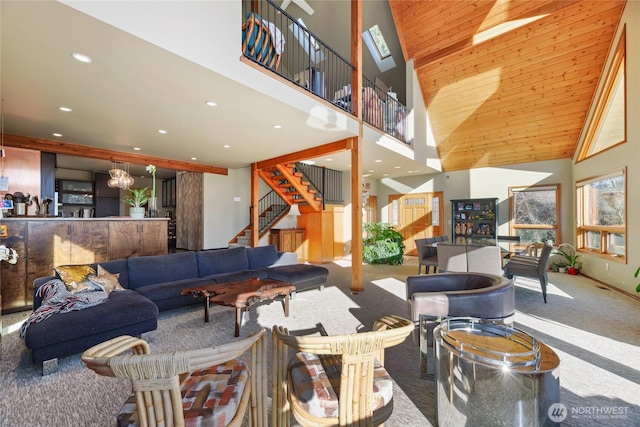 living area with recessed lighting, carpet floors, a high ceiling, a skylight, and stairs