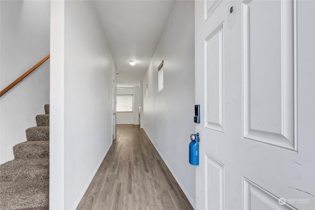 corridor with light hardwood / wood-style floors