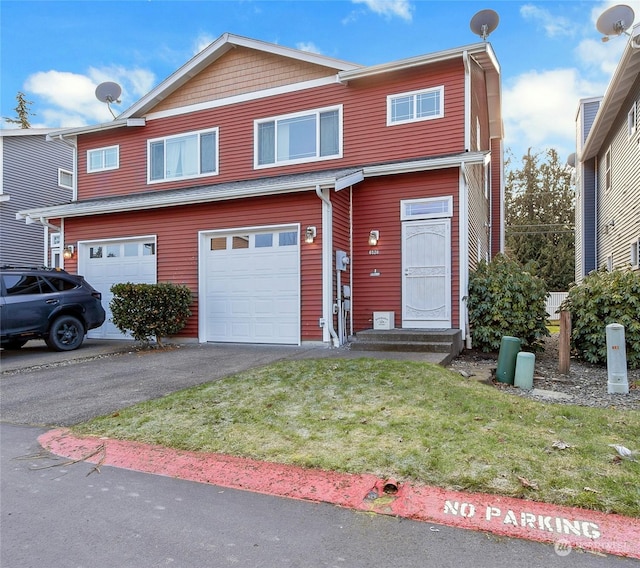 view of front of property featuring a garage and a front yard