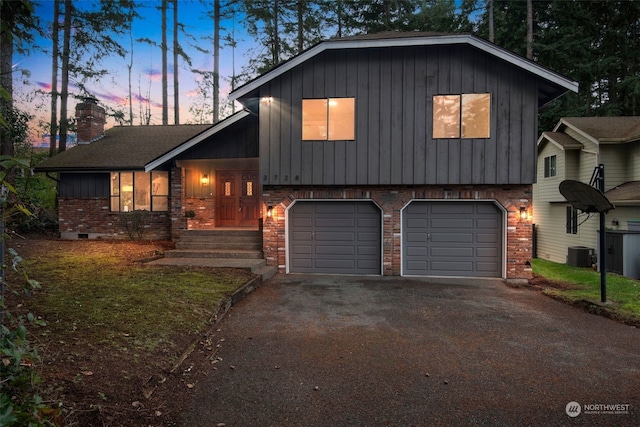 split level home featuring a garage and central air condition unit