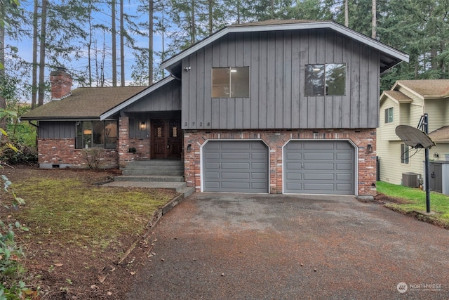 split level home with a garage and central air condition unit