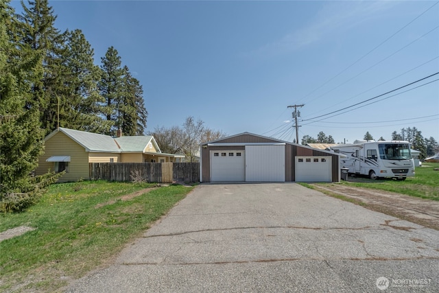 exterior space with an outdoor structure, fence, and a garage