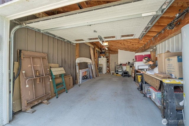 garage with freestanding refrigerator and a garage door opener
