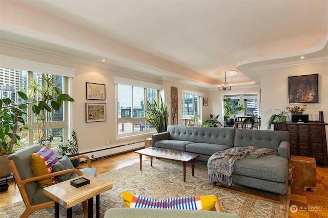 living room featuring ornamental molding, a wealth of natural light, and a baseboard heating unit