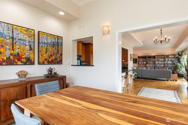 dining space with an inviting chandelier and crown molding