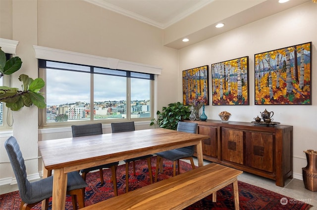 dining space featuring crown molding