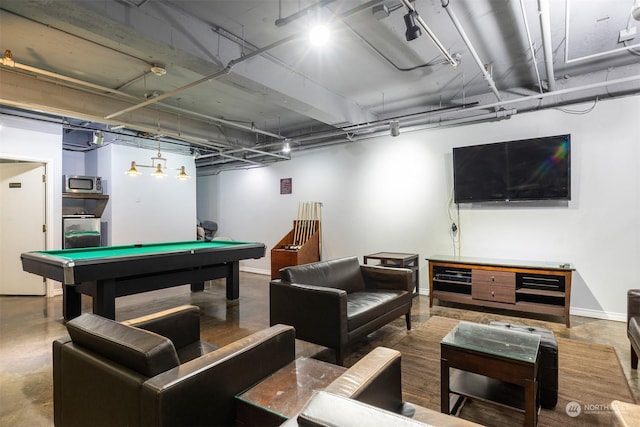 recreation room featuring pool table, washer / clothes dryer, and concrete flooring