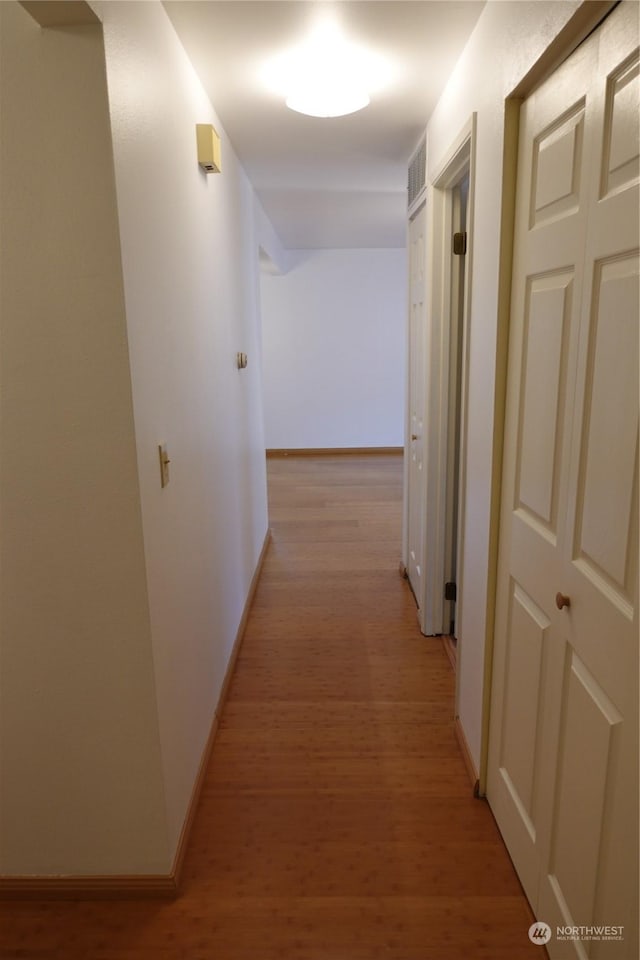 hallway featuring light hardwood / wood-style flooring