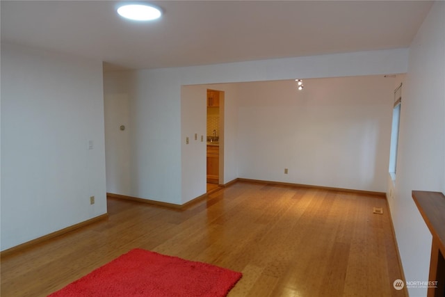 unfurnished room with wood-type flooring