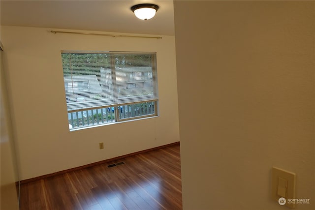 empty room with hardwood / wood-style floors