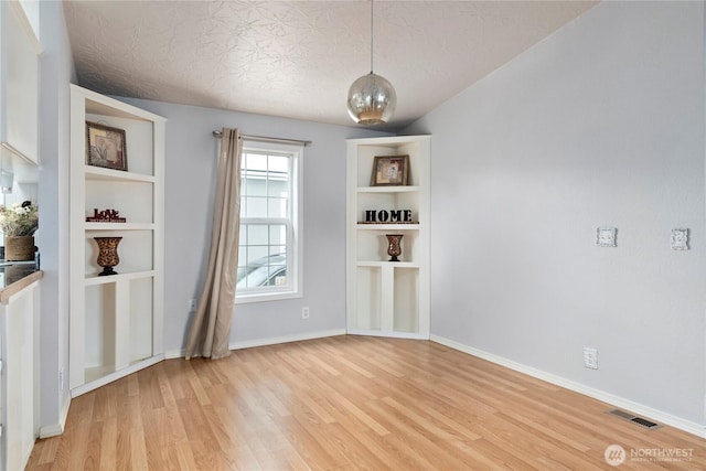 unfurnished room featuring light hardwood / wood-style floors