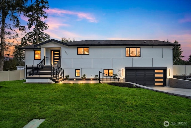 contemporary house with a garage and a lawn