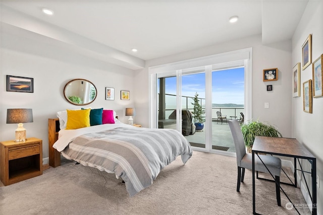 carpeted bedroom featuring access to outside, a water view, and recessed lighting