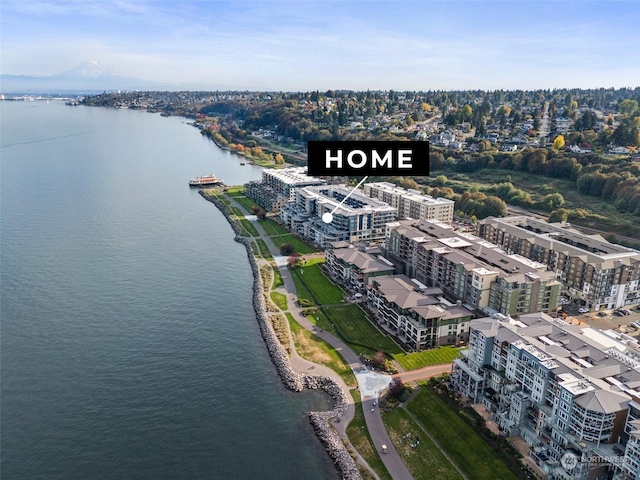 birds eye view of property with a view of city and a water view