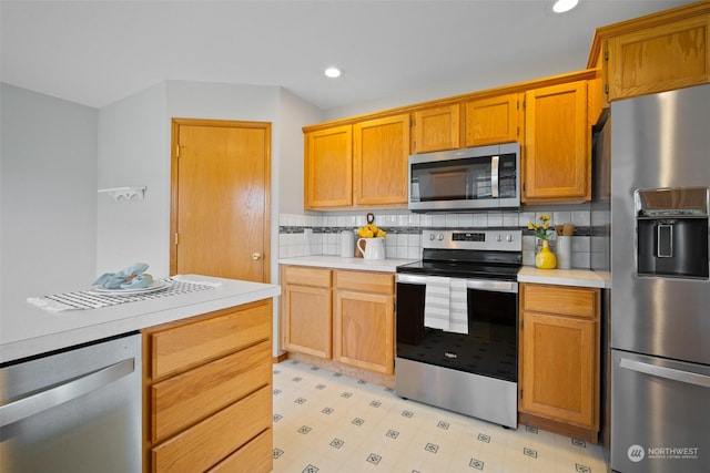 kitchen featuring stainless steel appliances and decorative backsplash