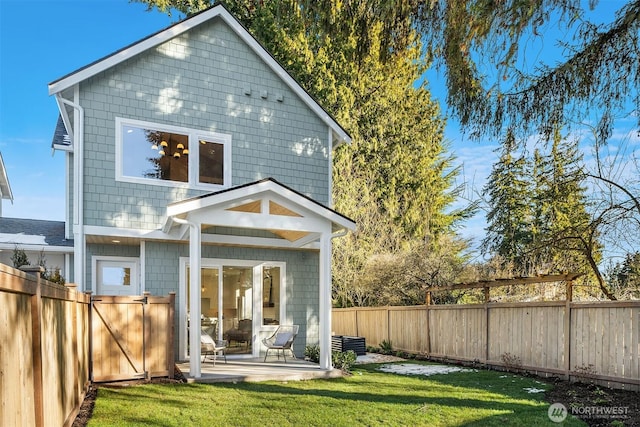 rear view of property featuring a yard and a patio