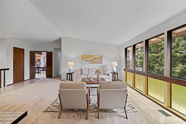 living room featuring light carpet and lofted ceiling