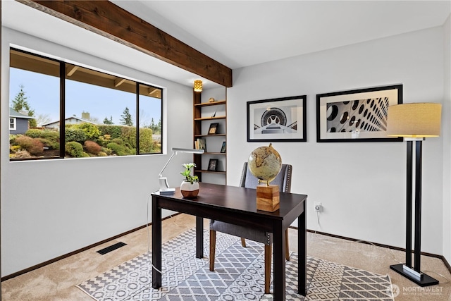 carpeted office featuring beam ceiling