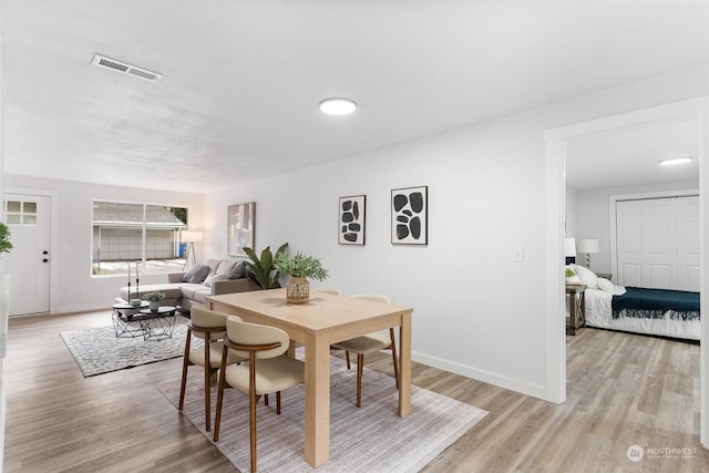 dining area with light hardwood / wood-style flooring