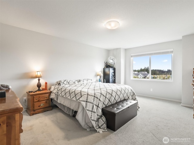 bedroom featuring light carpet